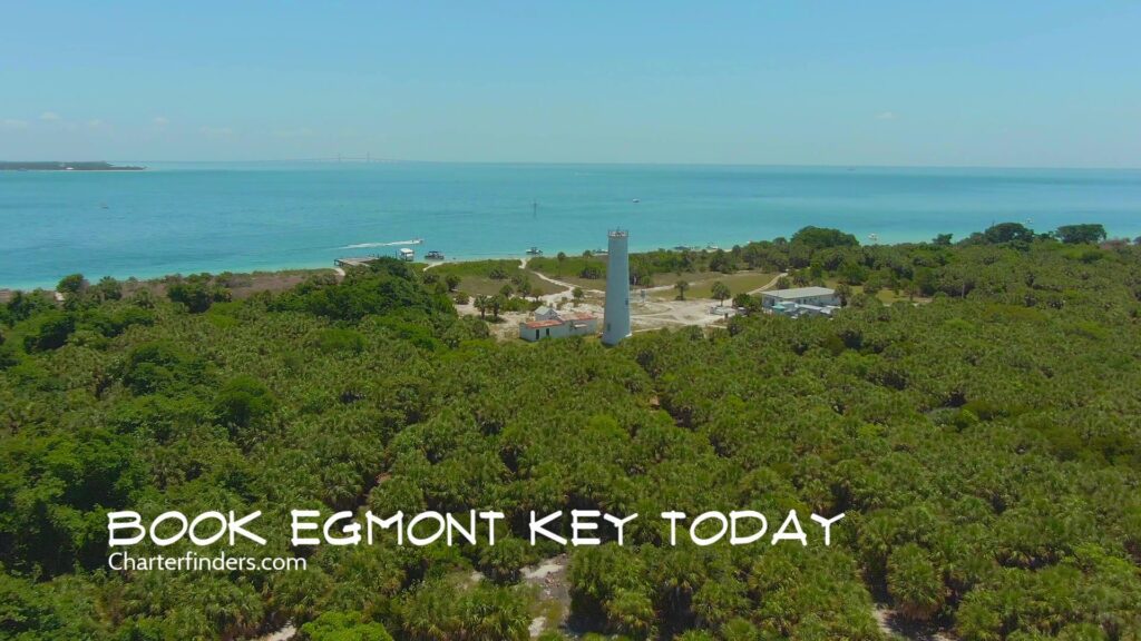 Aerial view of Egmont Key with a lighthouse, surrounded by greenery and water, with promotional text "Book your Egmont Key dolphin cruise today" at the bottom.