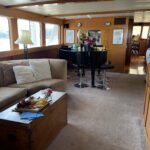 Inside image of a yatch with a white color sofa