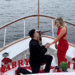 A boy proposing a girl on a white color ship