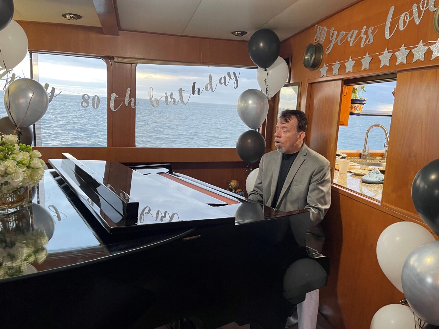 A man playing piano in a moving ship