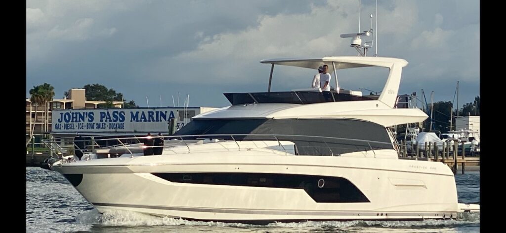 Luxury yacht rentals cruising near a marina in Clearwater.